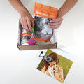 Life's Abundance cat gift basket being unboxed, with treats, a supplement jar and cat toys