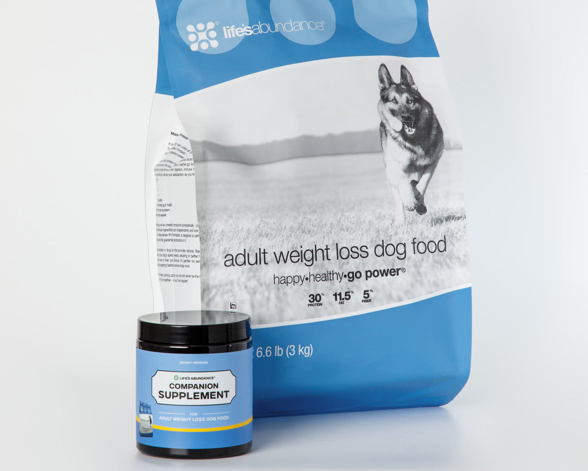 Daily Nutrition System: bag of adult weight loss dog food with its Companion Supplement chews jar on a white studio background