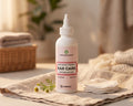 Ear Care bottle for dogs and cats on a linen cloth beside cotton pads and chamomile flowers