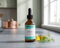 Omega-3 EPA/DHA fish oil for dogs and cats, amber dropper bottle on a slate kitchen counter beside a small dish of oil and a sprig of dill