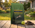 Performance Dog Food for All Life Stages 40 lb bag on a sunlit backyard deck with a tennis ball and leash