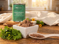 Pork & Venison Recipe 13 oz can beside a bowl of the food, parsley and flaxseed on a kitchen table