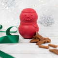 Red rubber snowman treat dispenser with a green ribbon and dog treats