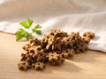 Star-shaped Wellness Food Supplement pieces for cats in warm morning light